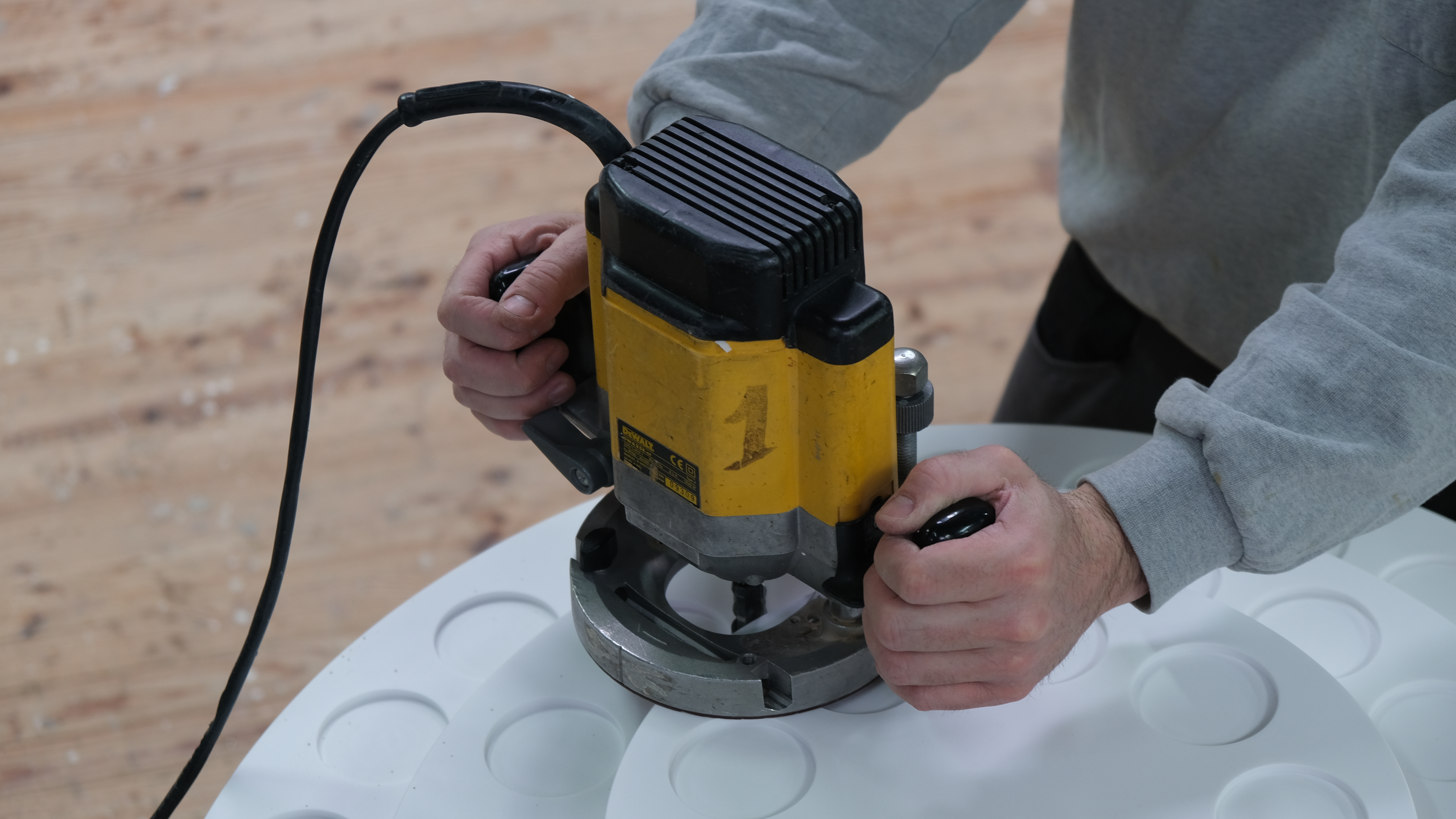 Menuisier réglant la machine combinée toupie Martin dans l'atelier